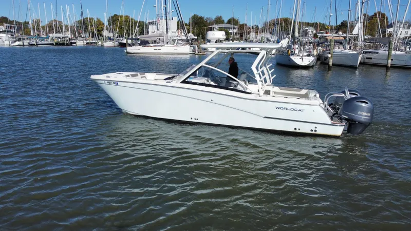 The Image of 2020 World Cat 280 DC x boat cruising in a marina with sailboats in the background. - 0