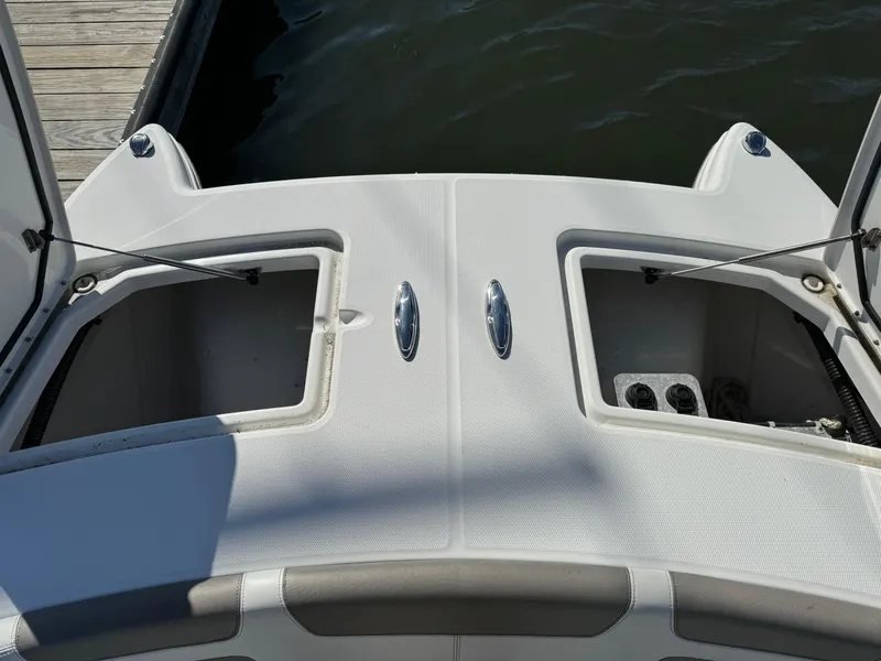 Slide: The Image of 2020 World Cat 280 DC x boat storage compartments open at dock. - 11