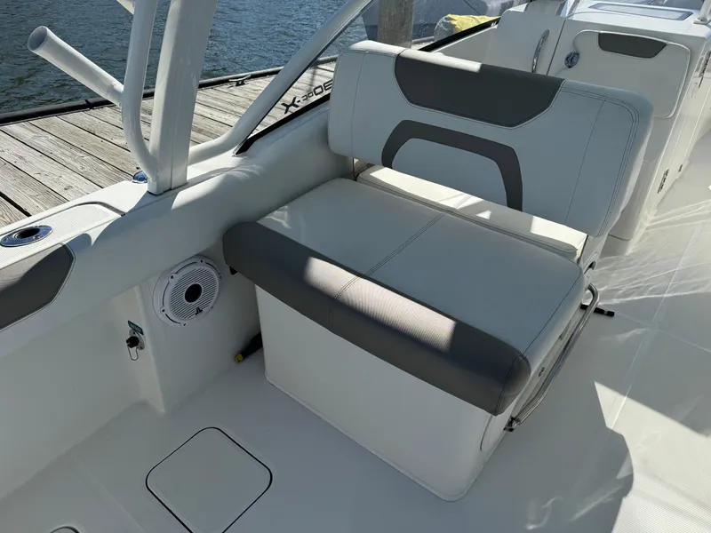Slide: The Image of 2020 World Cat 280 DC x boat interior with cushioned seating and speaker. - 24