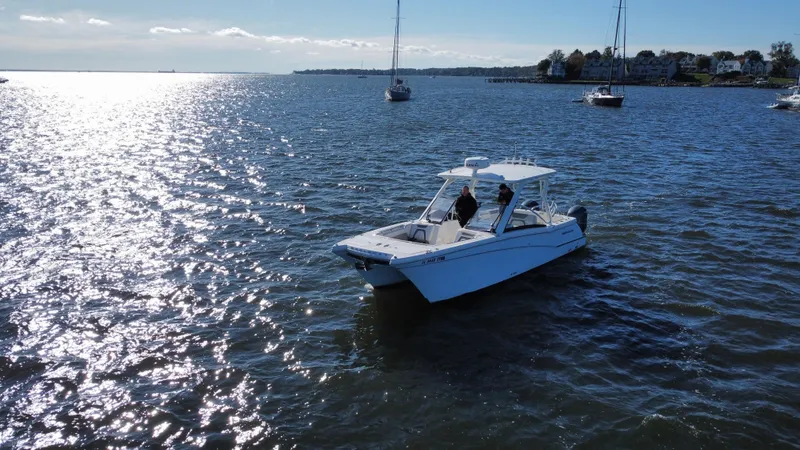 Slide: The Image of 2020 World Cat 280 DC x boat on sunny waters with distant sailboats. - 29