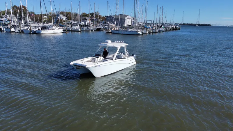 Slide: The Image of 2020 World Cat 280 DC x boat cruising near marina with sailboats. - 3