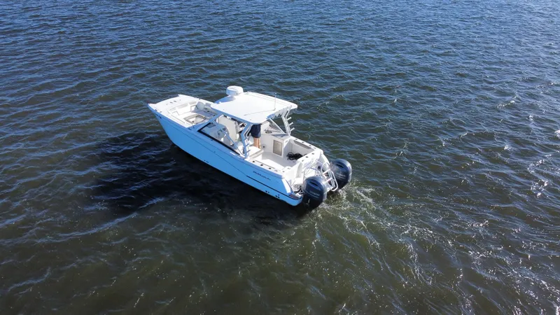 Slide: The Image of 2020 World Cat 280 DC x boat cruising on open water. - 34