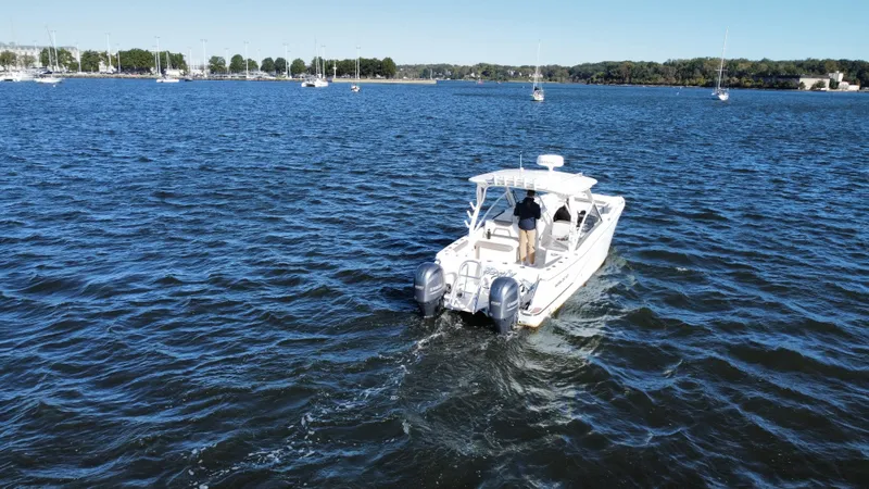 Slide: The Image of 2020 World Cat 280 DC x boat cruising on a calm lake. - 6