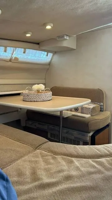 Slide: The Image of Interior of 2002 Bayliner 2655 Ciera with cozy seating and table arrangement. - 10