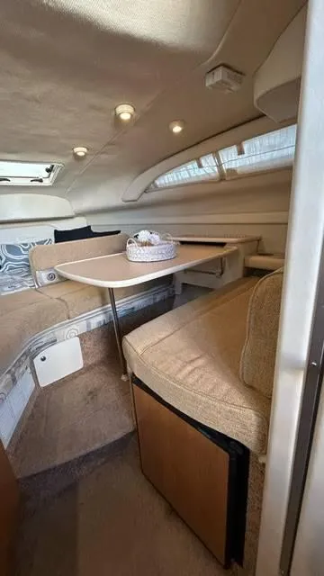 Slide: The Image of Interior of 2002 Bayliner 2655 Ciera boat with cozy seating and table. - 12