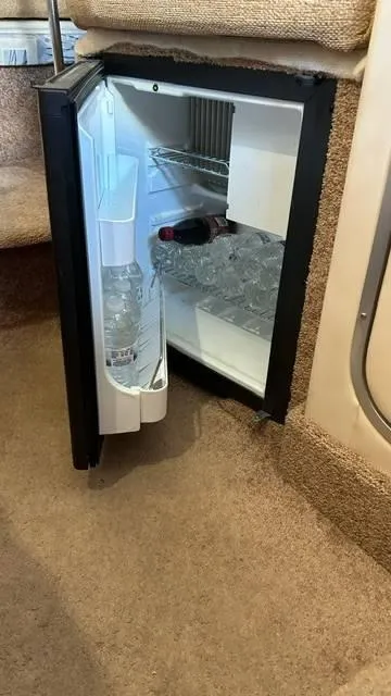 Slide: The Image of Mini fridge inside 2002 Bayliner 2655 Ciera boat, stocked with drinks and ice. - 14