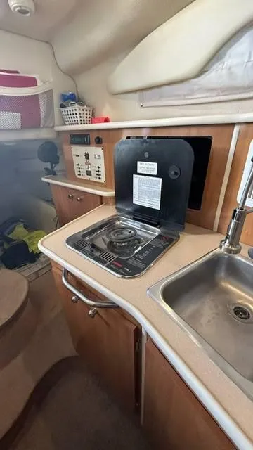 Slide: The Image of 2002 Bayliner 2655 Ciera boat kitchen with stove and sink. - 15
