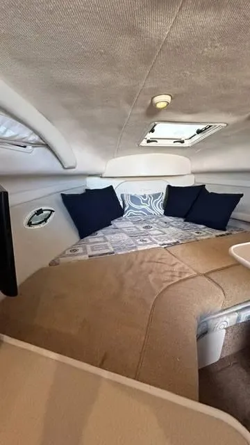 Slide: The Image of Interior cabin of 2002 Bayliner 2655 Ciera with cozy bedding and cushions. - 17