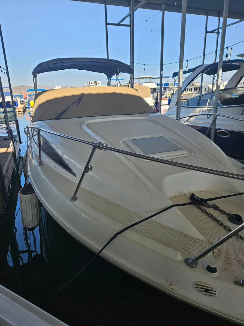 Slide: The Image of 2002 Bayliner 2655 Ciera boat docked in marina, covered and secured. - 7