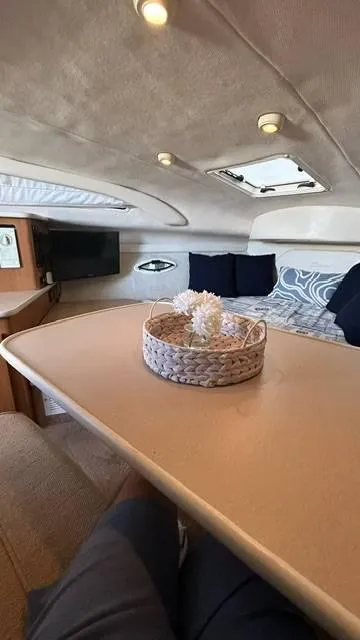 Slide: The Image of Interior of 2002 Bayliner 2655 Ciera with cozy seating and decorative basket. - 8