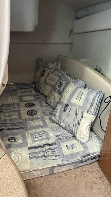Slide: The Image of 2002 Bayliner 2655 Ciera cabin interior with patterned bedding and cushions. - 9