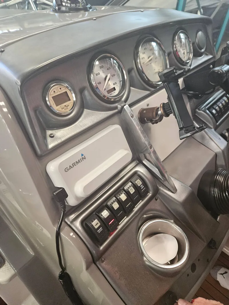 Slide: The Image of 2009 Monterey 260SCR boat dashboard with Garmin navigation system and gauges. - 10