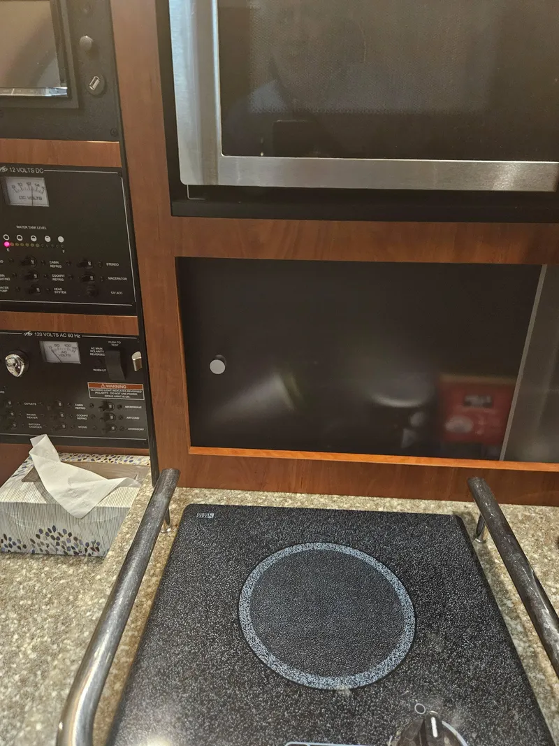 Slide: The Image of 2009 Monterey 260SCR interior with stove, microwave, and control panel. - 11