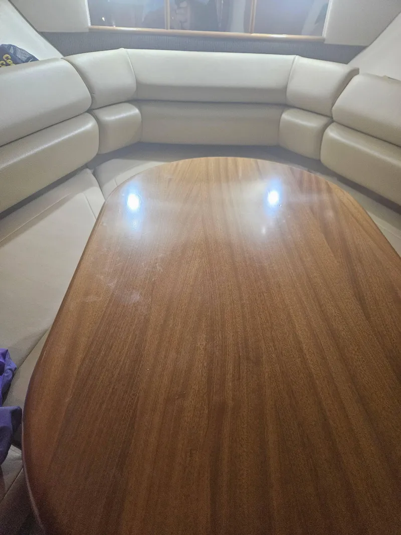Slide: The Image of Interior of 2009 Monterey 260SCR boat with wooden table and beige seating. - 14