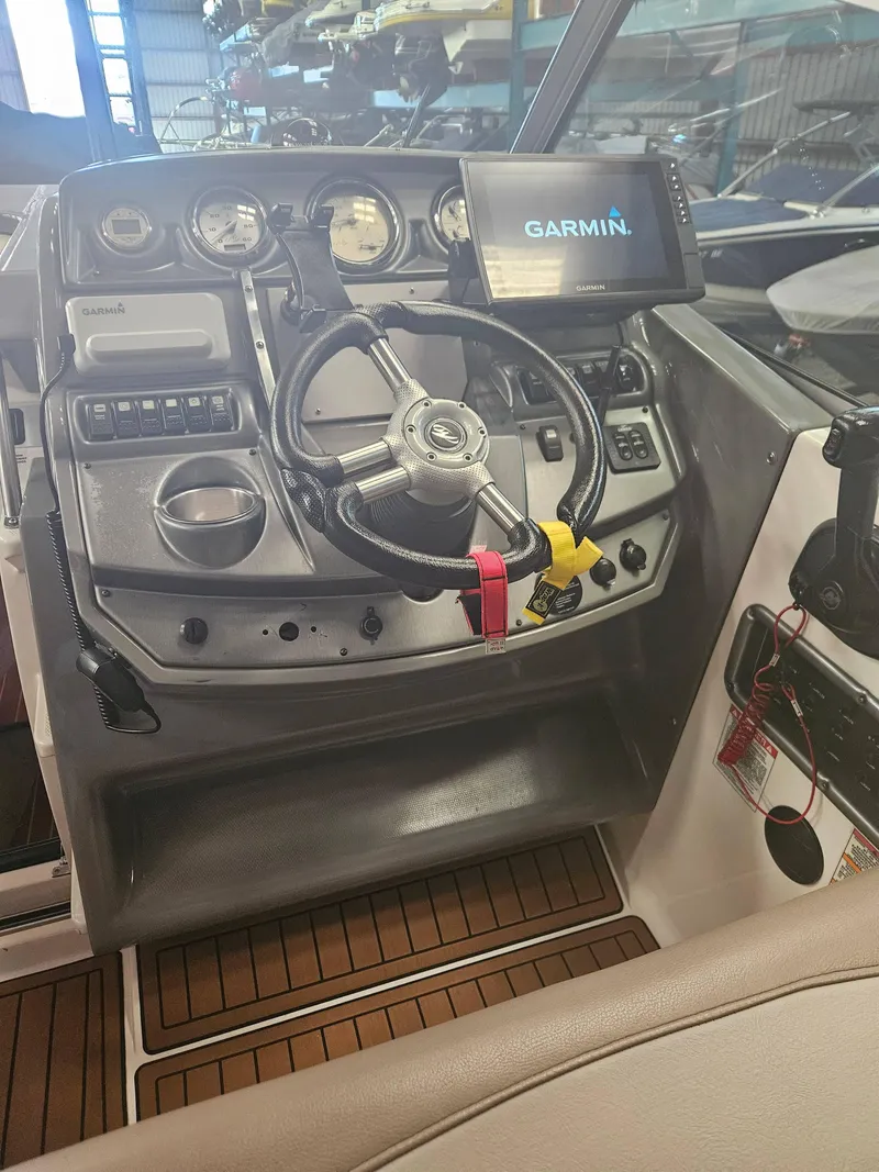 Slide: The Image of 2009 Monterey 260SCR boat dashboard with Garmin navigation system and steering wheel. - 15