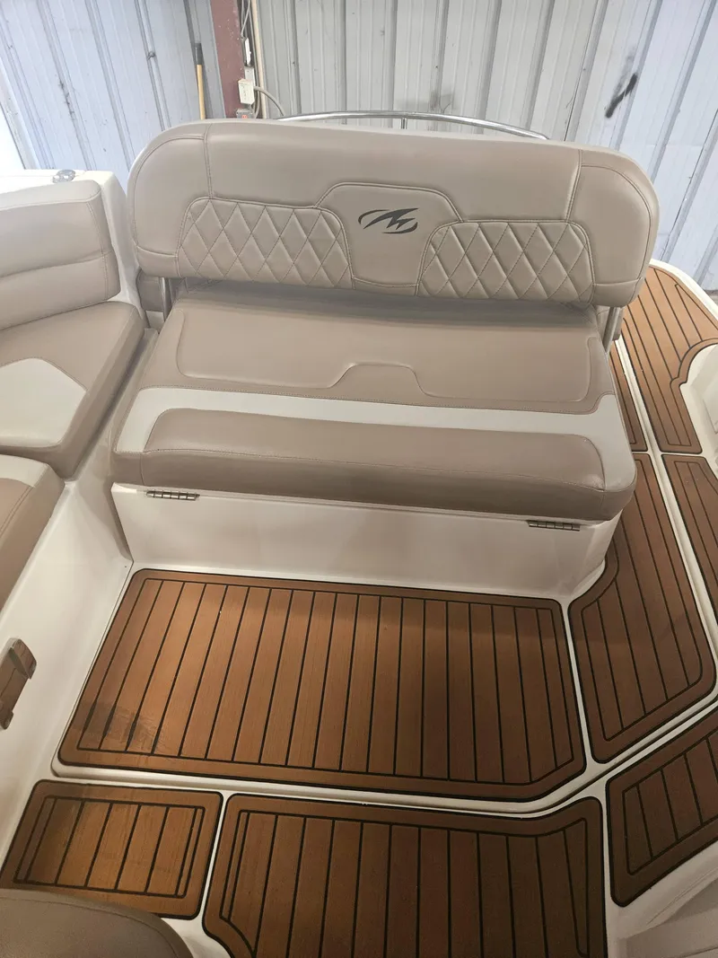 Slide: The Image of 2009 Monterey 260SCR boat interior with tan seating and wood-patterned flooring. - 17