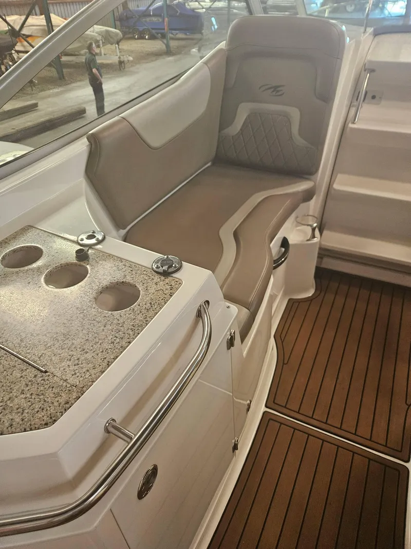 Slide: The Image of 2009 Monterey 260SCR boat interior with cushioned seating and granite countertop. - 19
