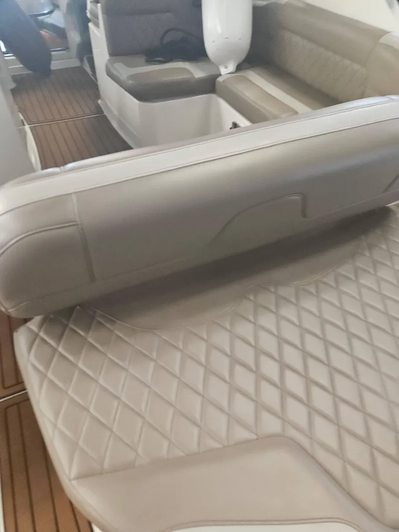 Slide: The Image of 2009 Monterey 260SCR boat interior with beige leather seating and wood flooring. - 20