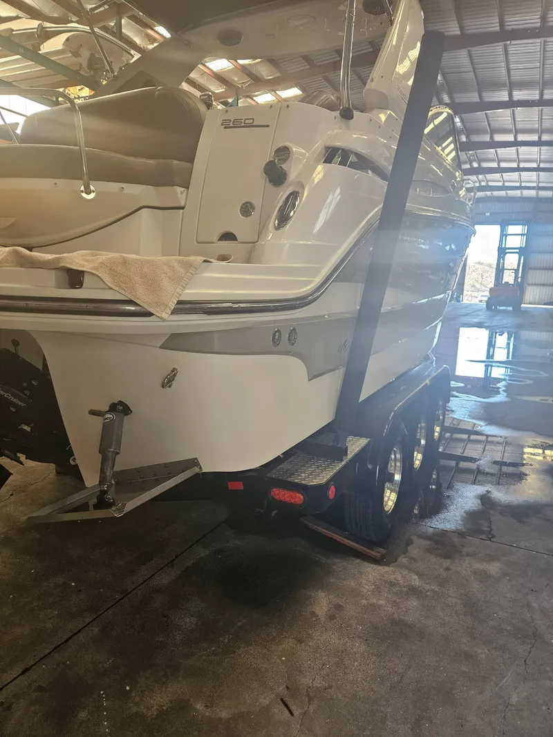 Slide: The Image of 2009 Monterey 260SCR boat on trailer in a warehouse setting. - 3