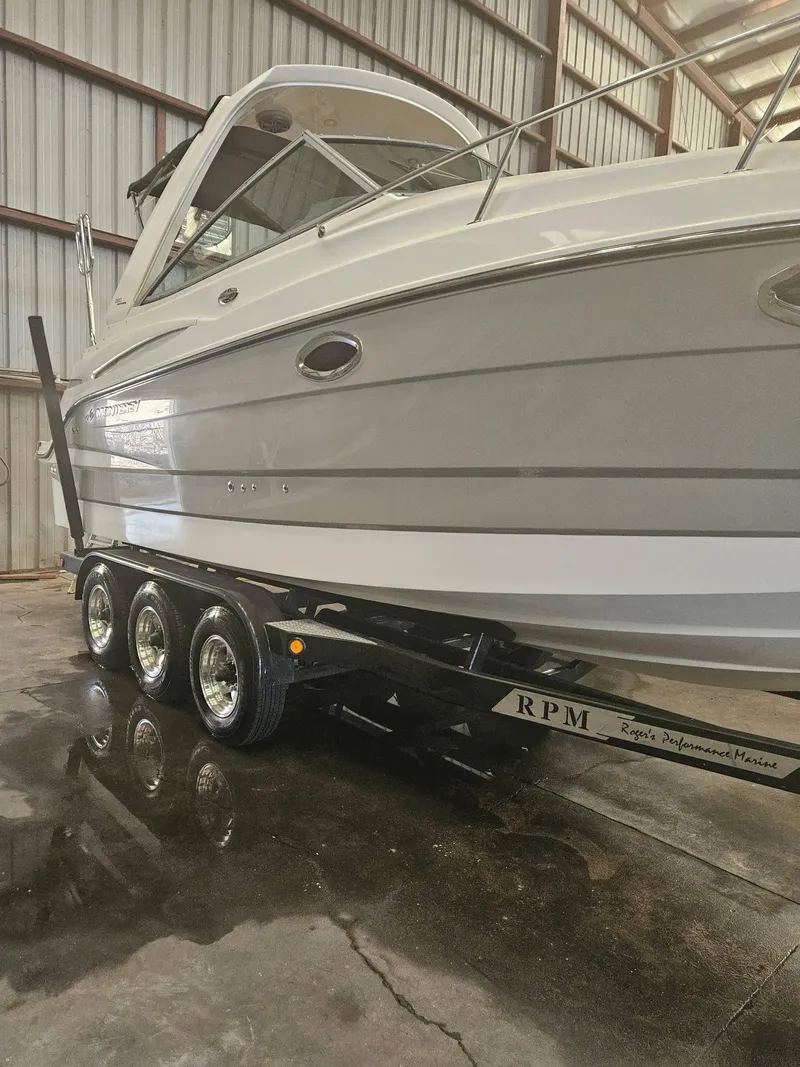 Slide: The Image of 2009 Monterey 260SCR boat on trailer in warehouse setting. - 4