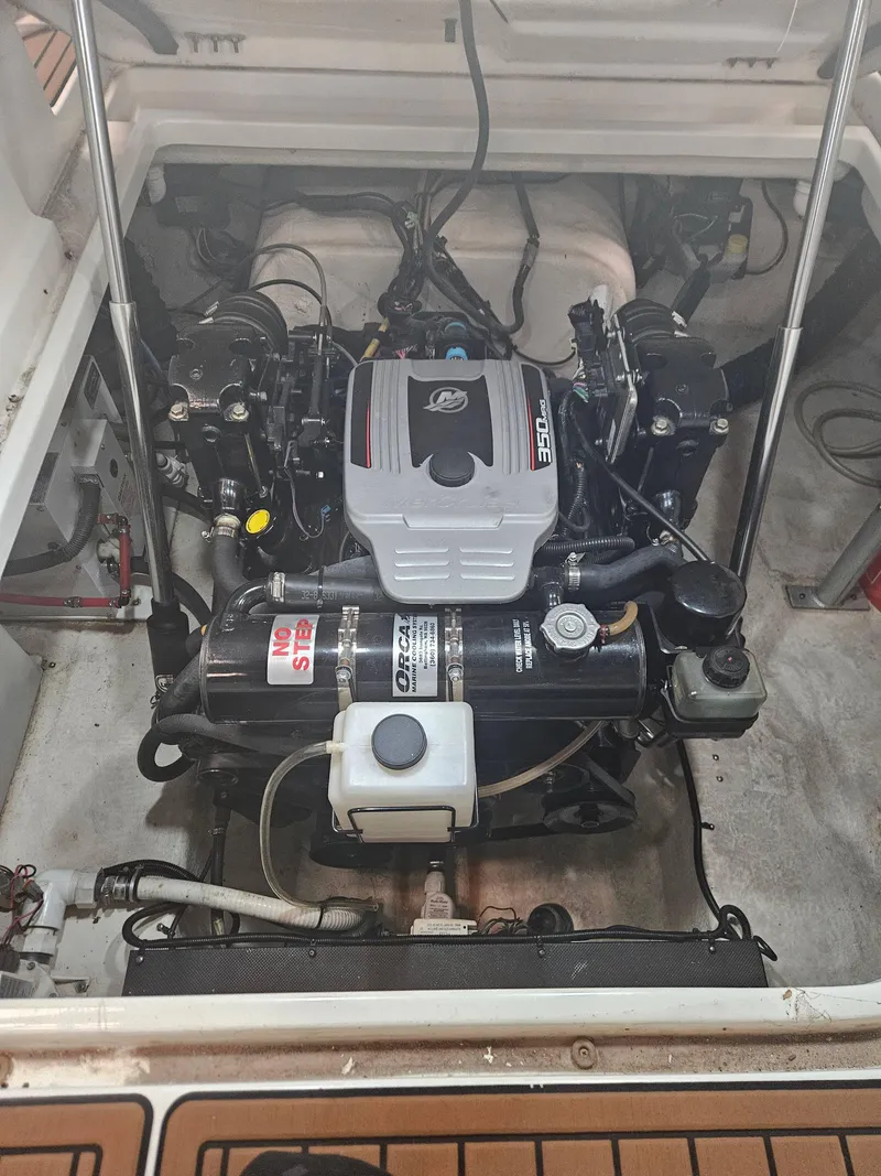 Slide: The Image of 2009 Monterey 260SCR engine compartment with MerCruiser 350 engine, clean and well-maintained. - 9