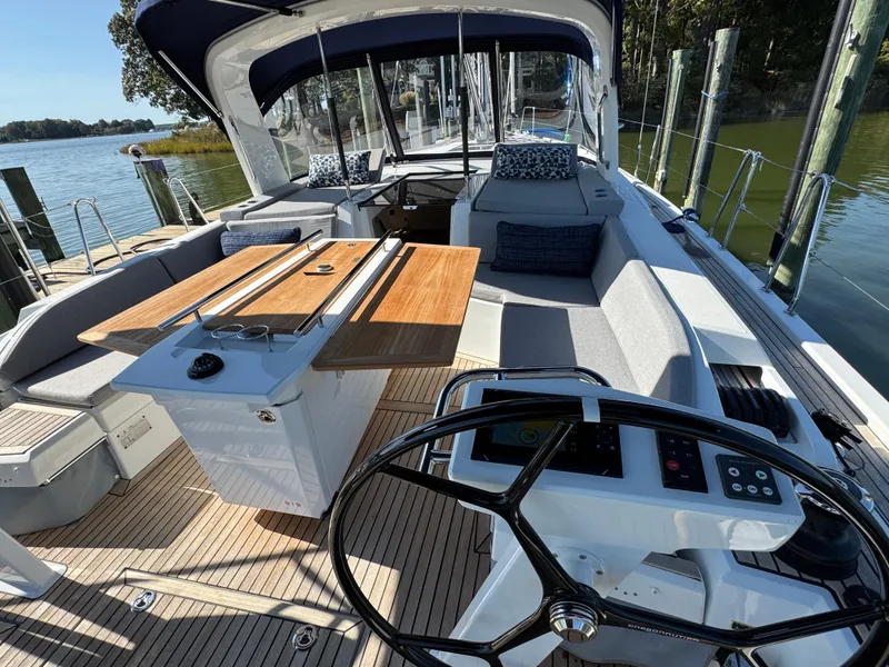 Slide: The Image of 2022 Beneteau Oceanis 46.1 yacht interior with helm, seating, and dining area. - 11