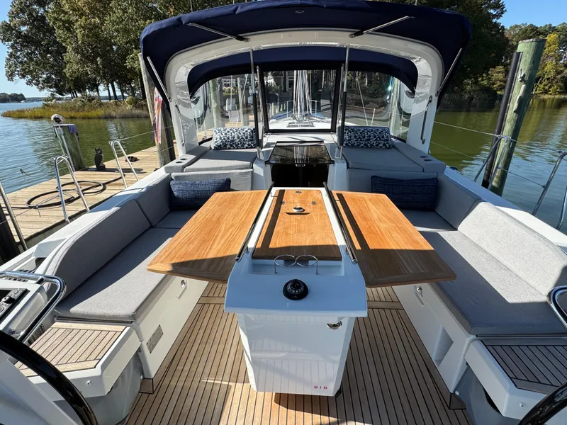 Slide: The Image of Beneteau Oceanis 46.1 yacht interior, 2022 model, featuring spacious seating and elegant wood table. - 13