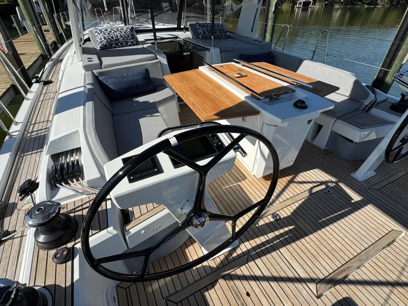 Slide: The Image of 2022 Beneteau Oceanis 46.1 yacht cockpit with dual steering wheels and teak decking. - 14