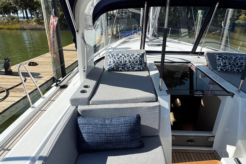 Slide: The Image of 2022 Beneteau Oceanis 46.1 yacht with cushioned seating and open cabin entrance. - 20