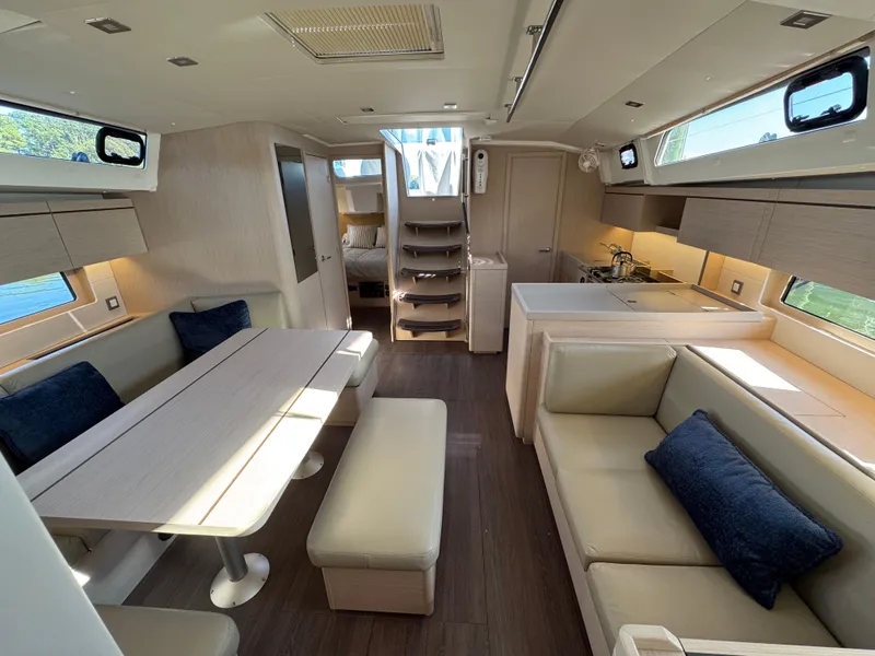 Slide: The Image of Interior of 2022 Beneteau Oceanis 46.1 yacht, featuring modern seating and dining area. - 21