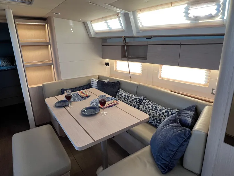 Slide: The Image of Interior of 2022 Beneteau Oceanis 46.1 yacht with cozy dining area and modern decor. - 22