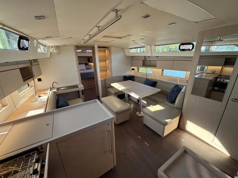 Slide: The Image of Interior of 2022 Beneteau Oceanis 46.1 yacht, featuring modern kitchen and dining area. - 29