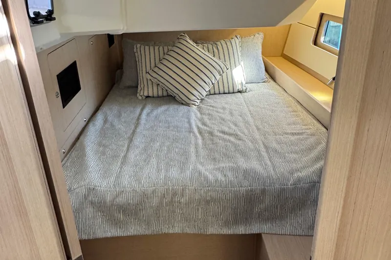 Slide: The Image of Cozy cabin interior of 2022 Beneteau Oceanis 46.1 with striped bedding and pillows. - 34