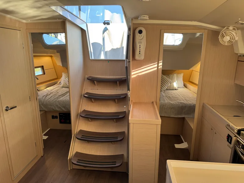 Slide: The Image of Interior of 2022 Beneteau Oceanis 46.1 yacht with modern wood finish and cozy cabins. - 36