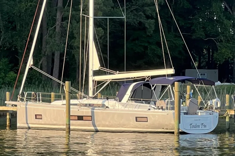 Slide: The Image of 2022 Beneteau Oceanis 46.1 sailboat docked by lush greenery. - 39