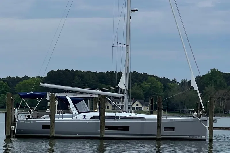 Slide: The Image of 2022 Beneteau Oceanis 46.1 sailboat docked on a calm lake. - 41