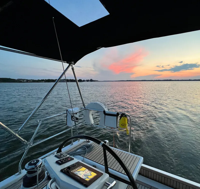 Slide: The Image of Beneteau Oceanis 46.1 sailboat at sunset, 2022 model, serene water view. - 6