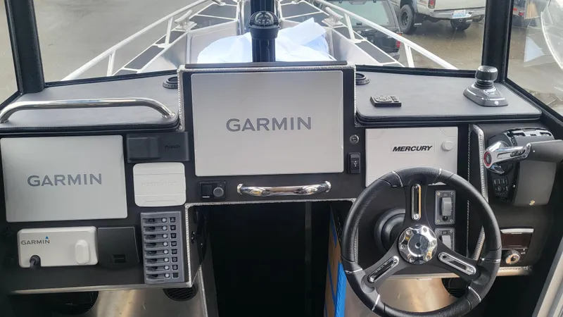 Slide: The Image of 2023 Life Proof 31 Walk Around Cabin boat dashboard with Garmin and Mercury controls. - 6