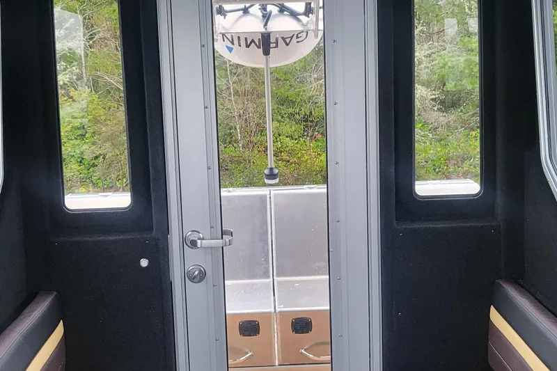 Slide: The Image of Interior view of 2023 Life Proof 31 Walk Around Cabin boat, featuring door and windows. - 8