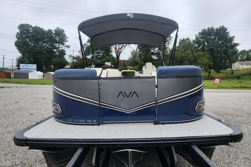 Slide: The Image of 2025 Avalon Platinum LSZ 2185 Quad Lounger Shift pontoon boat, rear view, parked outdoors. - 2