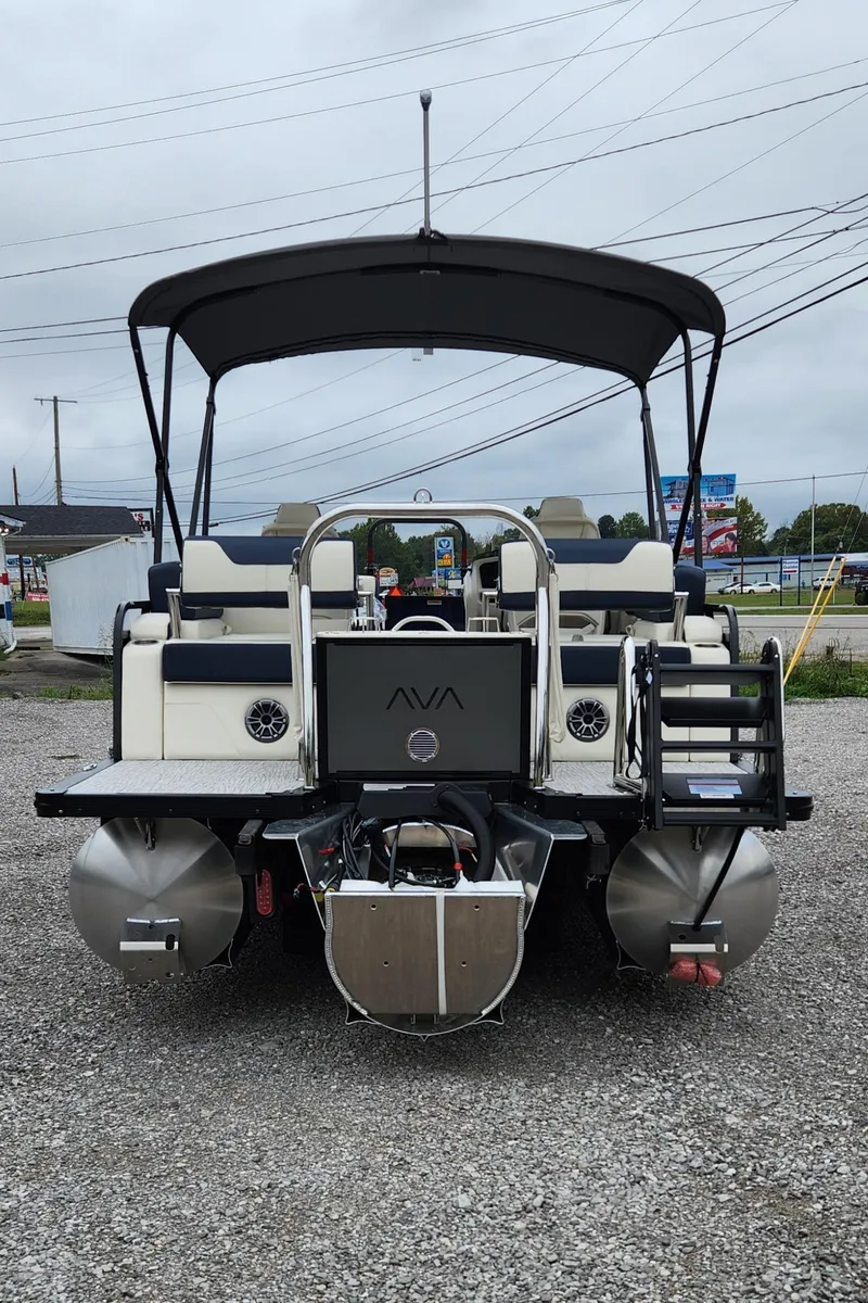 Slide: The Image of 2025 Avalon Platinum LSZ 2185 Quad Lounger Shift pontoon boat, rear view, parked on gravel. - 3
