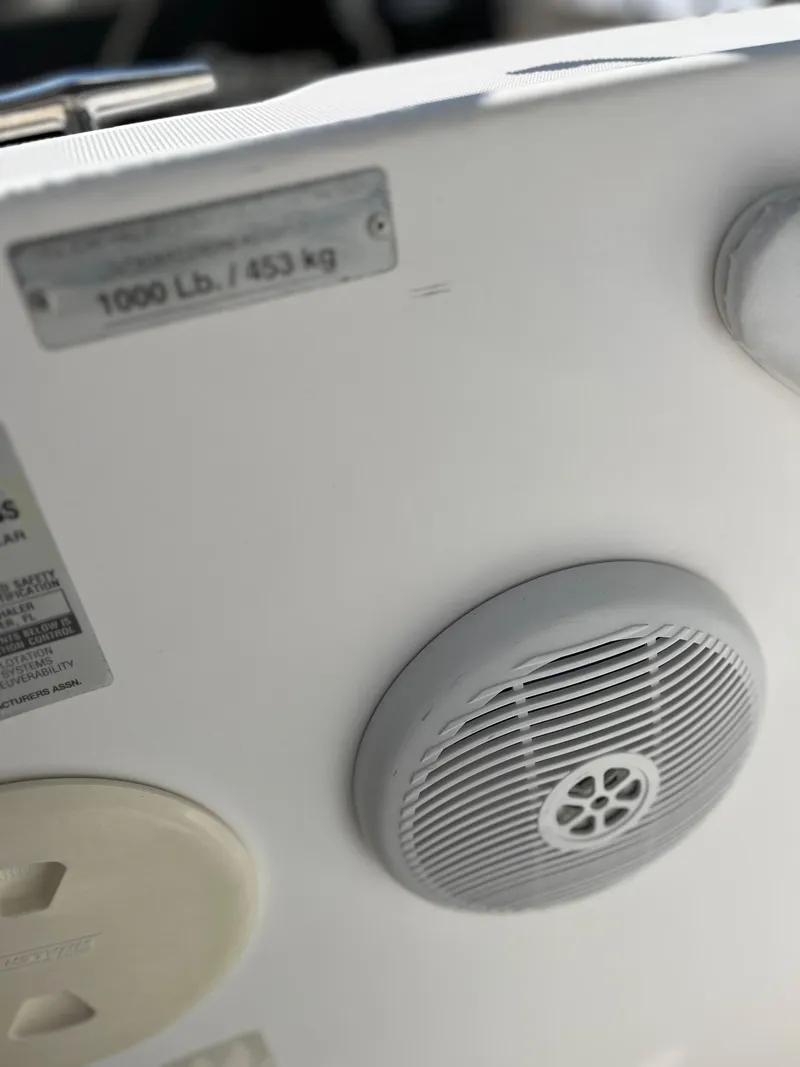 Slide: The Image of Close-up of Boston Whaler 240 Outrage 2004 boat speaker and weight capacity label. - 10