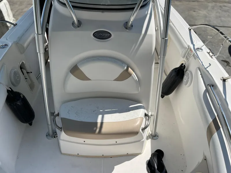 Slide: The Image of 2004 Boston Whaler 240 Outrage boat interior with seating and storage features. - 2
