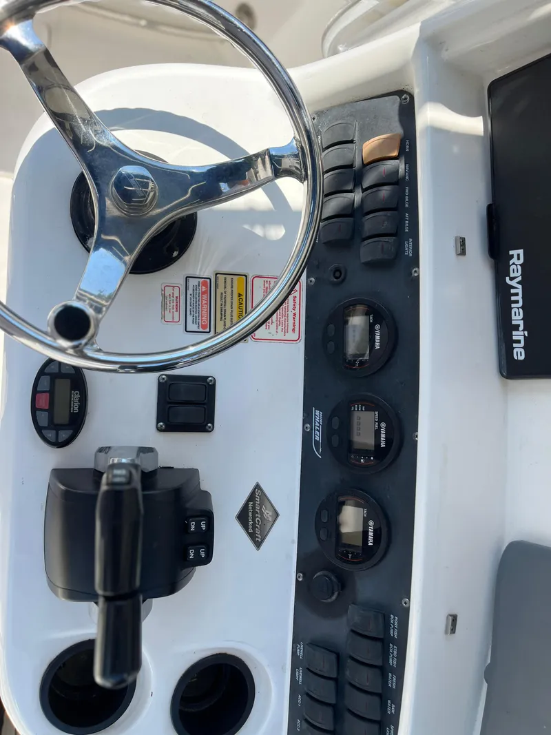 Slide: The Image of Boston Whaler 240 Outrage 2004 dashboard with steering wheel and Raymarine equipment. - 24