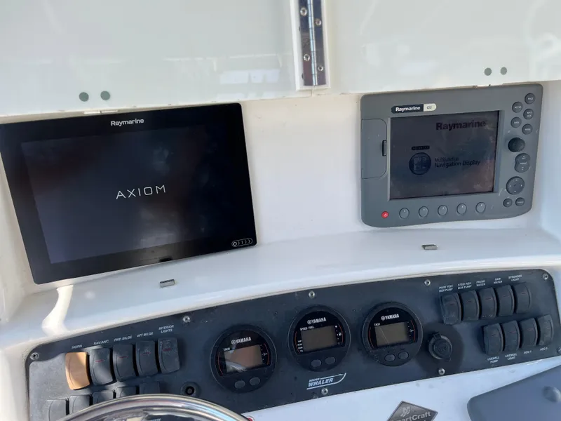 Slide: The Image of Boston Whaler 240 Outrage 2004 dashboard with Raymarine navigation displays. - 25