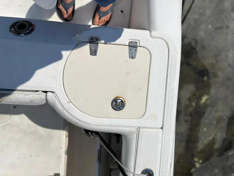 Slide: The Image of 2004 Boston Whaler 240 Outrage boat deck with storage compartment and hinges. - 36