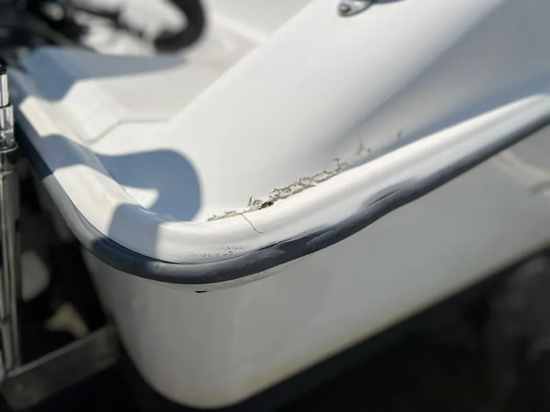 Slide: The Image of Close-up of 2004 Boston Whaler 240 Outrage boat with visible hull damage. - 37