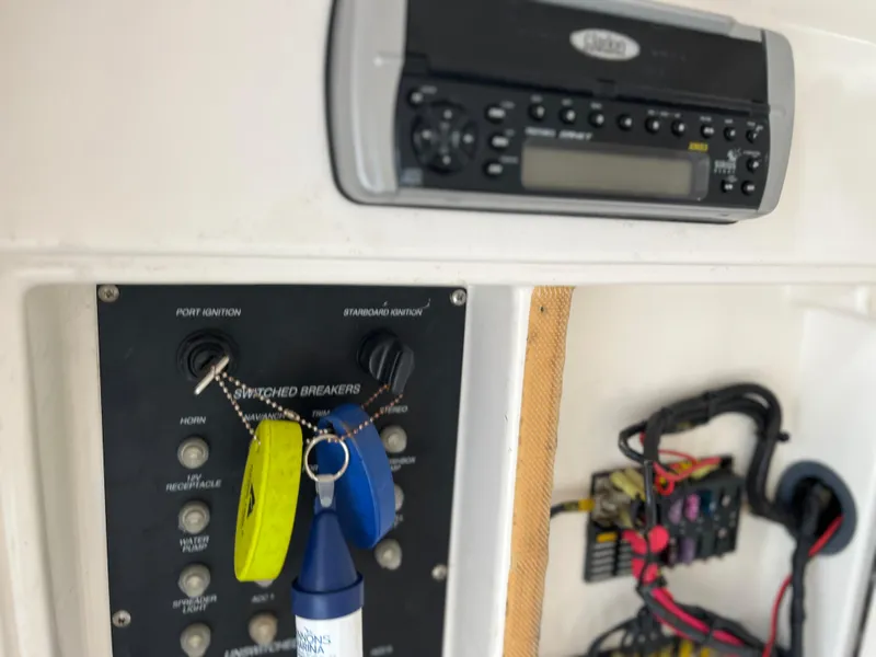 Slide: The Image of Control panel of a 2004 Boston Whaler 240 Outrage boat with ignition switches and keys. - 43