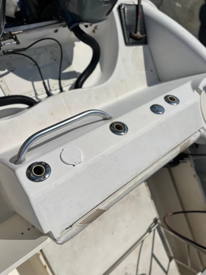 Slide: The Image of Boston Whaler 240 Outrage 2004 boat interior with rod holders and grab handle. - 45