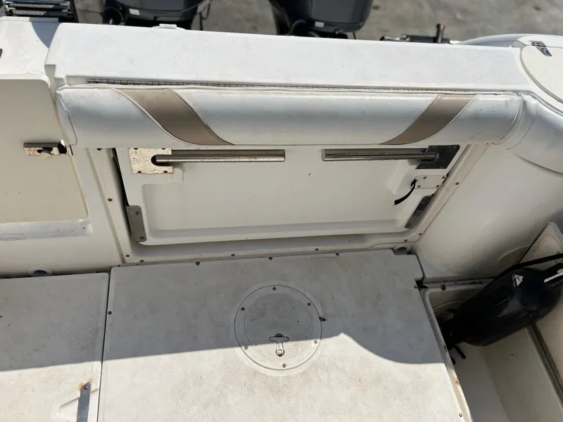 Slide: The Image of 2004 Boston Whaler 240 Outrage interior detail, featuring seating and storage area. - 5